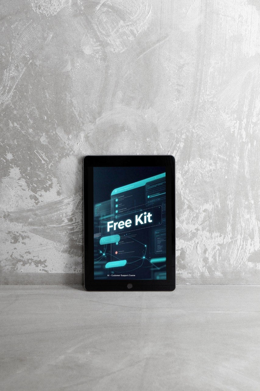 A black tablet device standing upright on a light gray surface against a textured gray wall, displaying a dark screen with cyan interface graphics and the words 'Free Kit'.